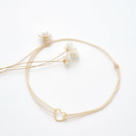 Bracelet coeur d'artichaut en coton caché dans une véritable coquille d'oeuf