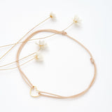 Bracelet coeur d'artichaut en coton caché dans une véritable coquille d'oeuf